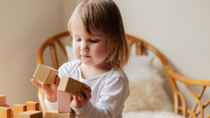 A kid playing with cubes